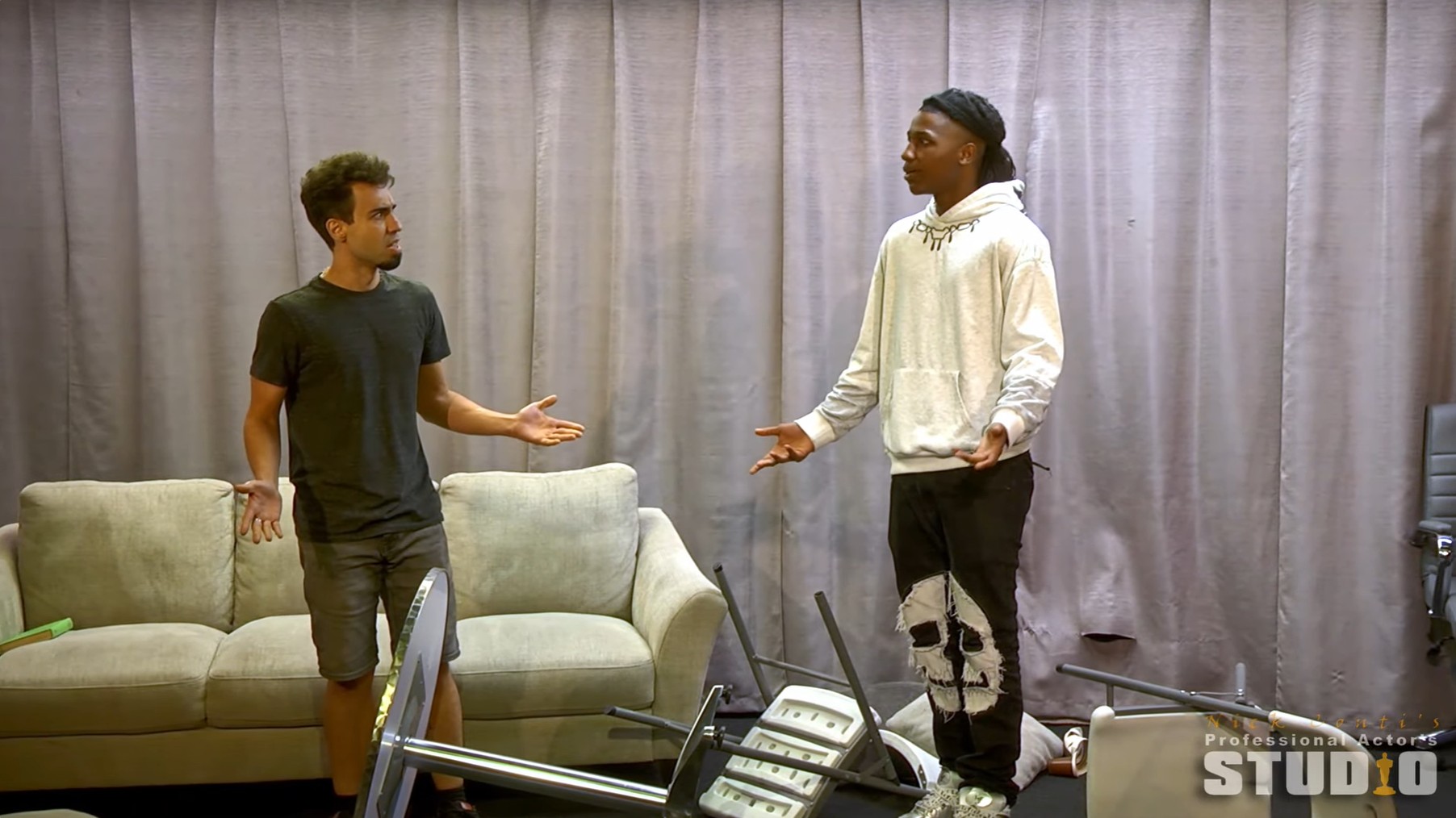 Two actors perform material at community showcase.